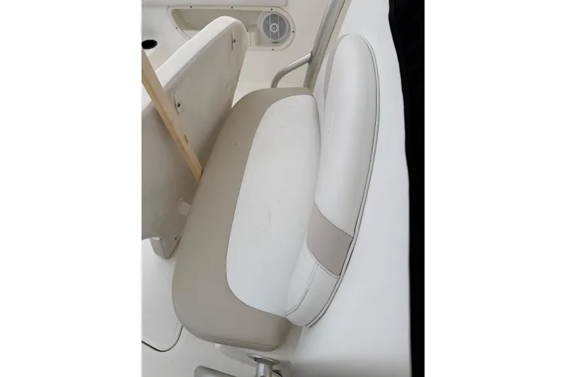 Slide: The Image of 2004 Boston Whaler 320 Outrage boat seat, white upholstery, close-up view. - 6