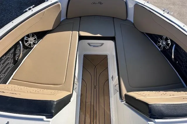 Slide: The Image of 2024 Sea Ray SPX 210 boat interior with tan seating and stylish wood flooring. - 10