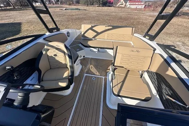 Slide: The Image of 2024 Sea Ray SPX 210 boat interior with tan seating and sleek design. - 11
