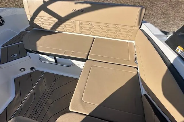 Slide: The Image of 2024 Sea Ray SPX 210 boat interior with tan seating and stylish design. - 15