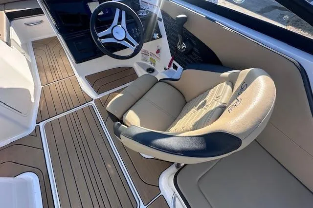 Slide: The Image of 2024 Sea Ray SPX 210 boat interior with tan seating and wood-style flooring. - 16