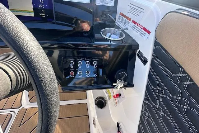 Slide: The Image of 2024 Sea Ray SPX 210 dashboard with control panel and steering wheel. - 17