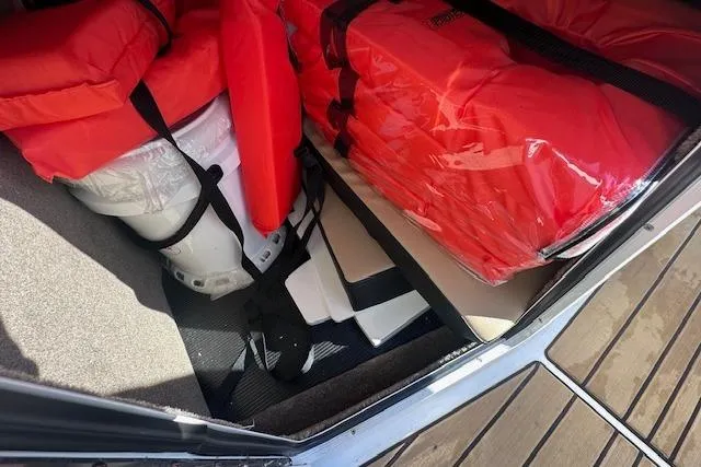 Slide: The Image of 2024 Sea Ray SPX 210 boat storage with life jackets and equipment. - 24