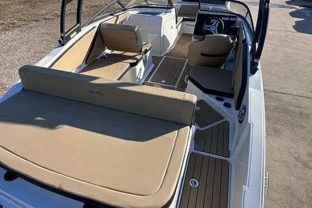 Slide: The Image of 2024 Sea Ray SPX 210 boat interior with tan seating and modern dashboard. - 7