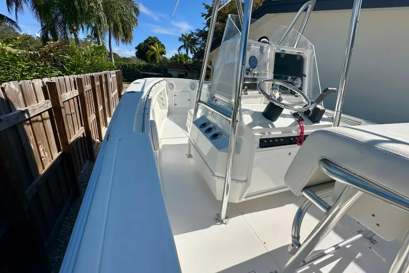 Slide: The Image of 2001 Contender 23 Open boat with T-top, parked beside a house. - 15