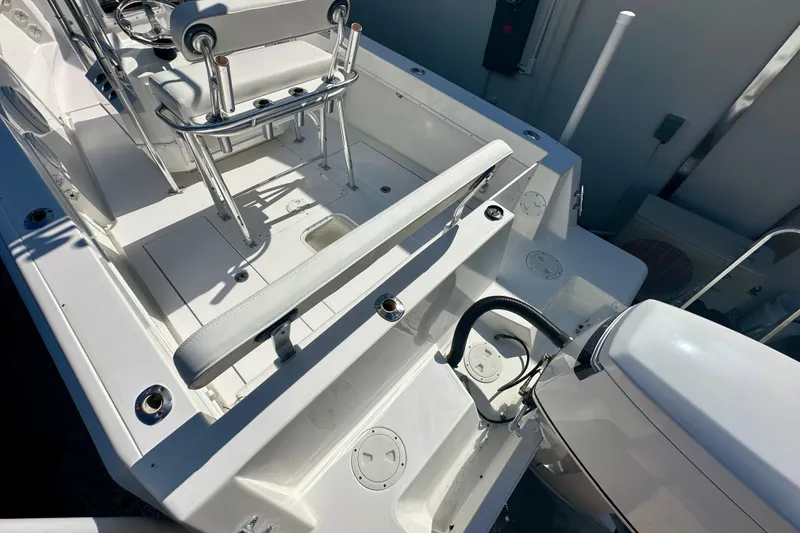 Slide: The Image of 2001 Contender 23 Open boat with T-top and seating, set against a sunny backdrop. - 21