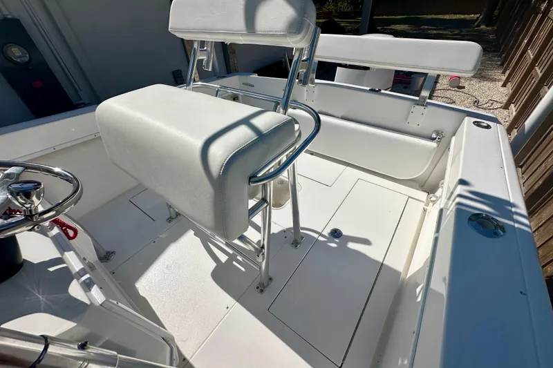 Slide: The Image of 2001 Contender 23 Open boat T-top with blue canvas under clear sky. - 25