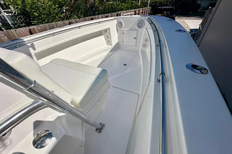 Slide: The Image of 2001 Contender 23 Open boat with center console, parked beside a house. - 30