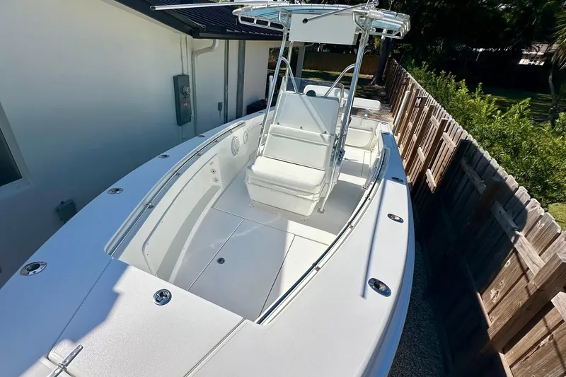 Slide: The Image of 2001 Contender 23 Open boat interior with white seating and steering wheel. - 34