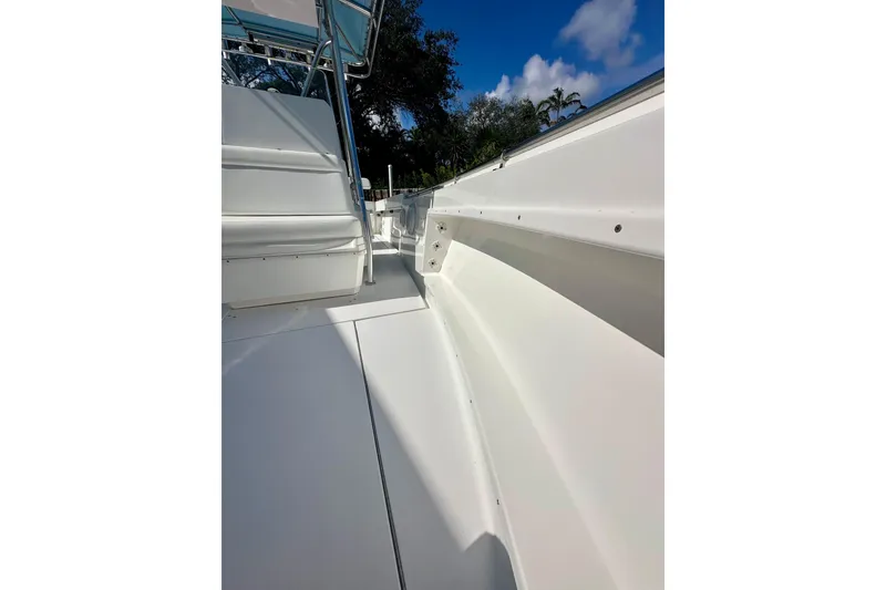 Slide: The Image of 2001 Contender 23 Open boat deck with seating, under clear blue sky. - 44