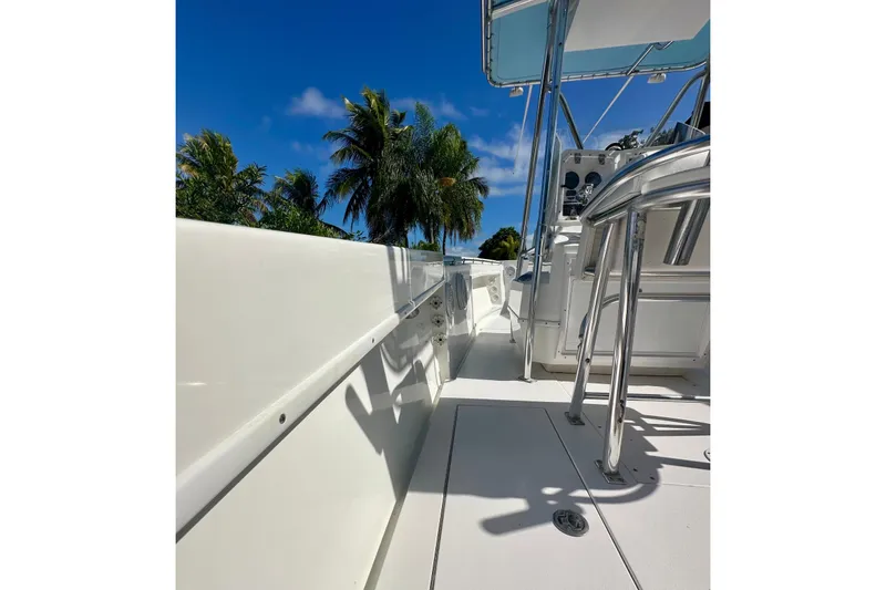 Slide: The Image of 2001 Contender 23 Open boat deck with palm trees and blue sky background. - 45