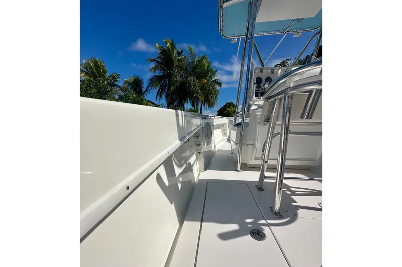 Slide: The Image of 2001 Contender 23 Open boat deck with seating, under a clear blue sky. - 46