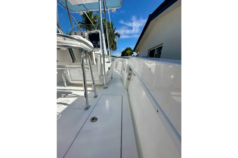 Slide: The Image of 2001 Contender 23 Open boat interior, featuring seating and fishing rod holders. - 47