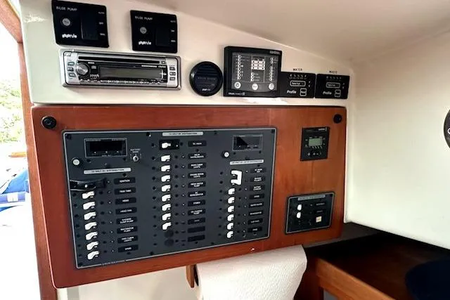 Slide: The Image of Electrical control panel of a 2007 Back Cove 29 boat with various switches and gauges. - 5