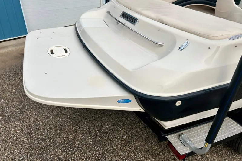 Slide: The Image of 1995 Crownline 202 BR boat rear view with swim platform and white upholstery. - 13