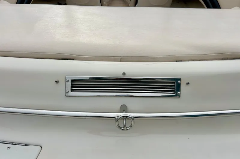 Slide: The Image of 1995 Crownline 202 BR boat interior with chrome details and beige upholstery. - 28