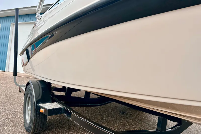 Slide: The Image of 1995 Crownline 202 BR boat on trailer, close-up view of hull and wheel. - 3