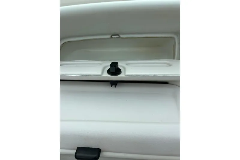 Slide: The Image of 1995 Crownline 202 BR boat interior compartment with latch, white finish. - 36
