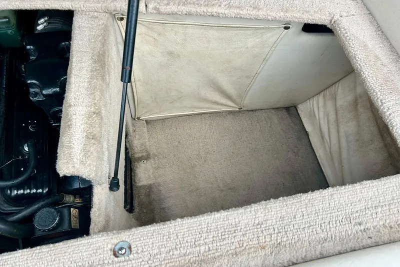 Slide: The Image of 1995 Crownline 202 BR engine compartment with beige carpeted interior. - 40