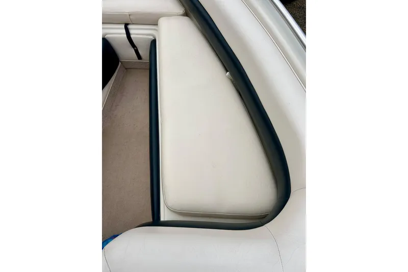 Slide: The Image of Interior seating of a 1995 Crownline 202 BR boat, featuring white upholstery. - 42