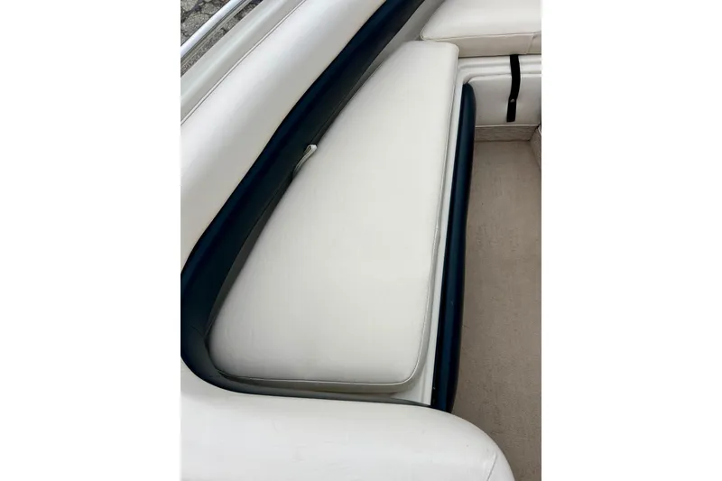 Slide: The Image of 1995 Crownline 202 BR boat interior with white and navy seating. - 44