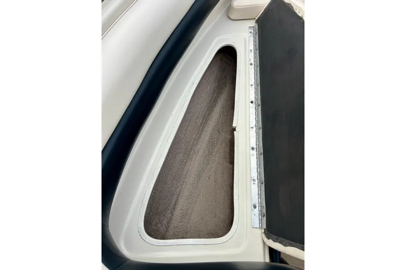Slide: The Image of 1995 Crownline 202 BR boat interior storage compartment with carpeted lining. - 45