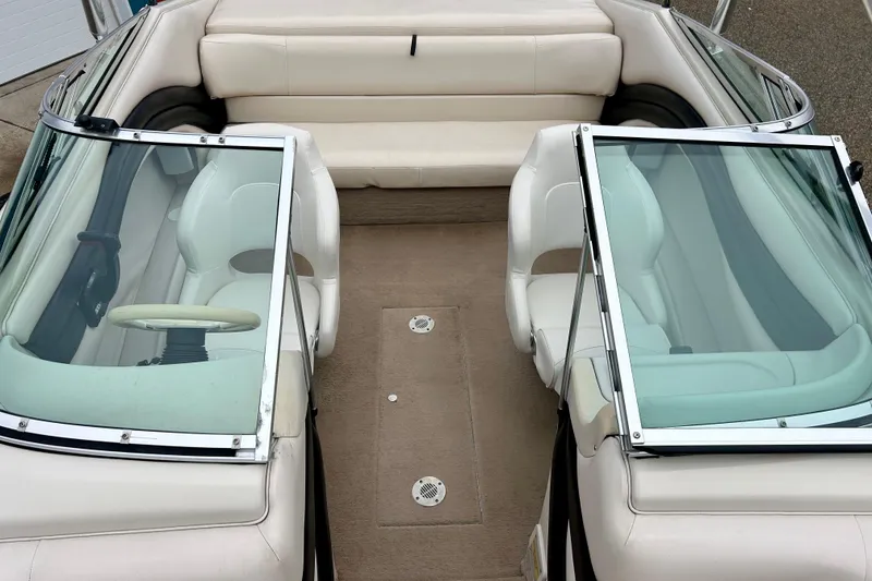 Slide: The Image of 1995 Crownline 202 BR boat interior with white seating and dual windshields. - 48