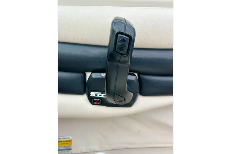 Slide: The Image of 1995 Crownline 202 BR boat throttle control with trim switch, black and beige interior. - 52