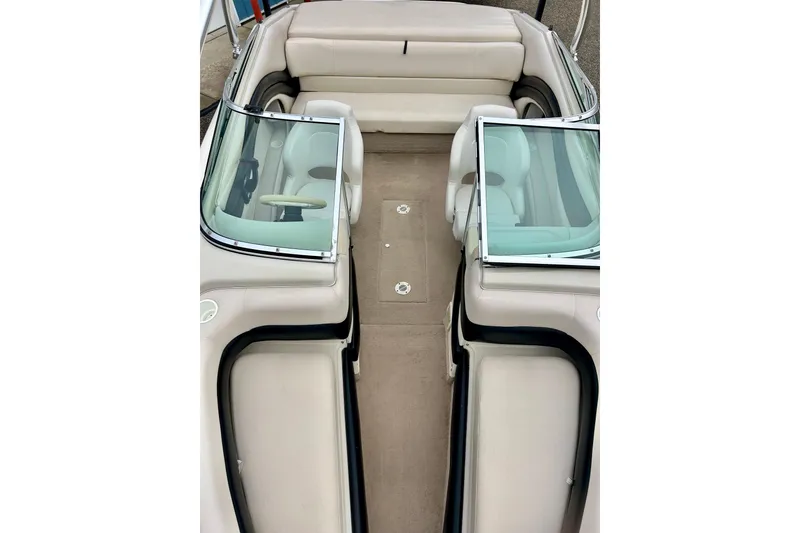 Slide: The Image of 1995 Crownline 202 BR boat interior with beige seating and windshield. - 53