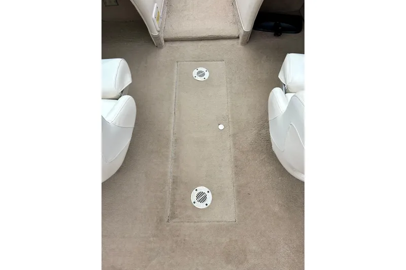 Slide: The Image of Interior of 1995 Crownline 202 BR boat with beige carpet and white seats. - 57