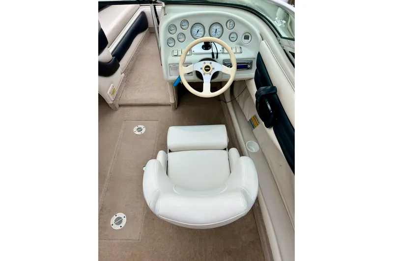 Slide: The Image of 1995 Crownline 202 BR boat interior with steering wheel and dashboard gauges. - 7