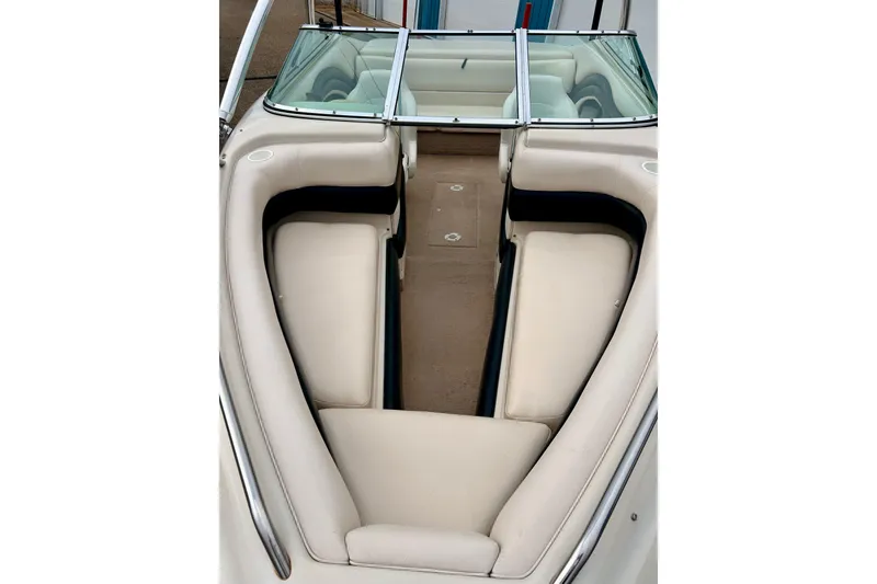 Slide: The Image of 1995 Crownline 202 BR boat interior with beige seating and windshield. - 8