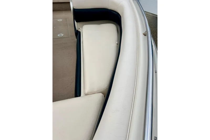 Slide: The Image of 1995 Crownline 202 BR boat interior with beige and navy seating. - 9