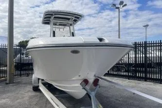 Slide: The Image of 2023 Trophy T24 CC boat on trailer, parked outdoors under cloudy sky. - 3