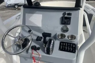 Slide: The Image of 2023 Trophy T24 CC boat console with steering wheel and controls. - 9