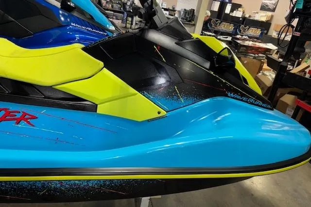 Slide: The Image of 2022 Yamaha WaveRunner JetBlaster in vibrant blue and yellow, displayed indoors. - 11