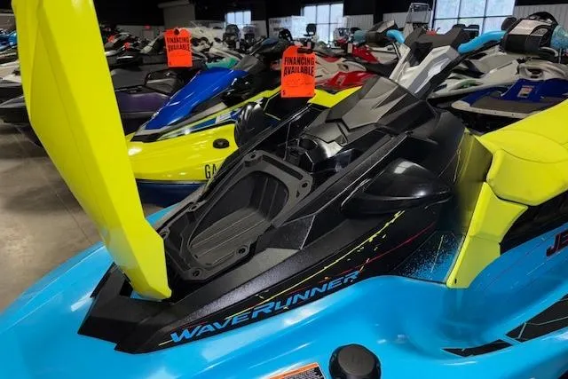Slide: The Image of 2022 Yamaha WaveRunner JetBlaster in showroom, vibrant blue and yellow design, financing available signs. - 15