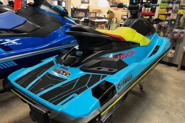 Slide: The Image of 2022 Yamaha WaveRunner JetBlaster in vibrant blue and yellow on display in a showroom. - 3