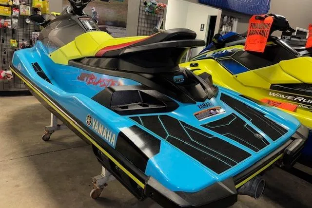 Slide: The Image of 2022 Yamaha WaveRunner JetBlaster in showroom, vibrant blue and yellow design. - 6
