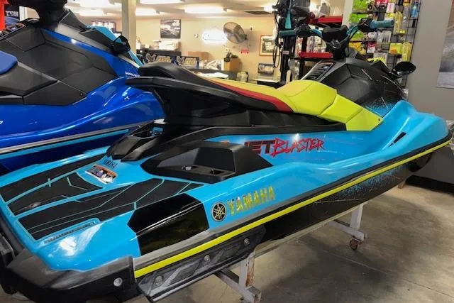Slide: The Image of 2022 Yamaha WaveRunner JetBlaster in showroom, vibrant blue and yellow design. - 7