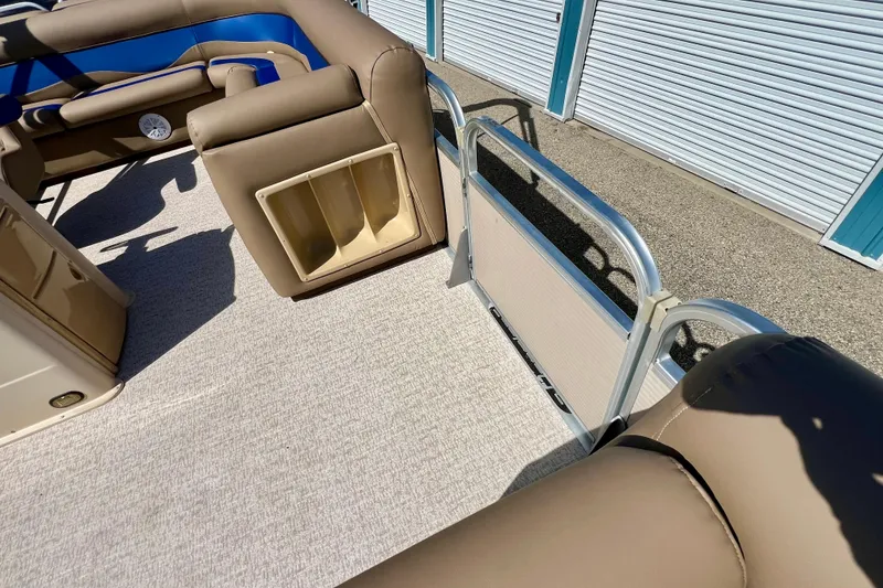 Slide: The Image of Interior of 2001 Premier 250 Grand Majestic pontoon boat with beige seating and storage compartments. - 11