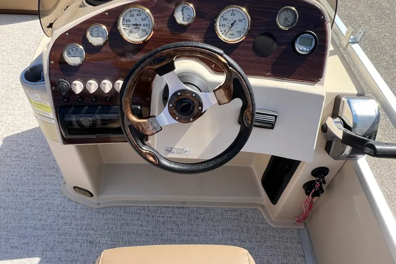 Slide: The Image of Steering console of a 2001 Premier 250 Grand Majestic boat with gauges and controls. - 18
