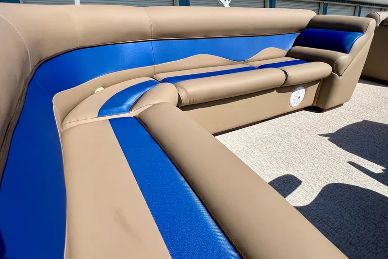 Slide: The Image of Luxurious seating in a 2001 Premier 250 Grand Majestic boat, featuring blue and beige upholstery. - 19