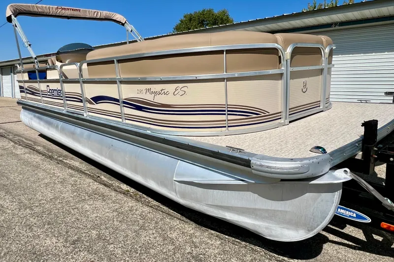 Slide: The Image of 2001 Premier 250 Grand Majestic pontoon boat on trailer, beige and blue design. - 2