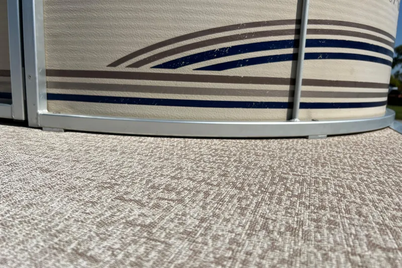 Slide: The Image of Close-up of 2001 Premier 250 Grand Majestic boat with striped design and textured flooring. - 25