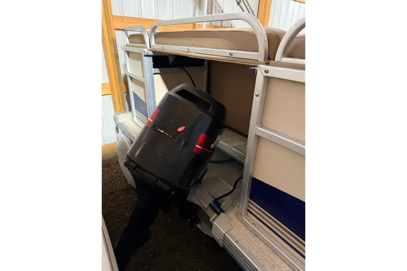 Slide: The Image of Close-up of a 2001 Premier 250 Grand Majestic boat motor on a gravel surface. - 32