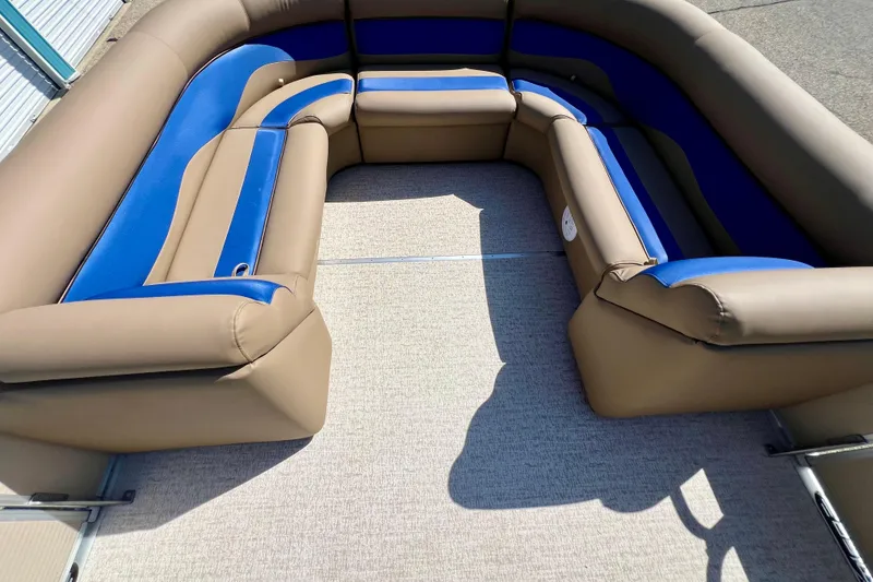 Slide: The Image of 2001 Premier 250 Grand Majestic boat interior with tan and blue seating. - 7