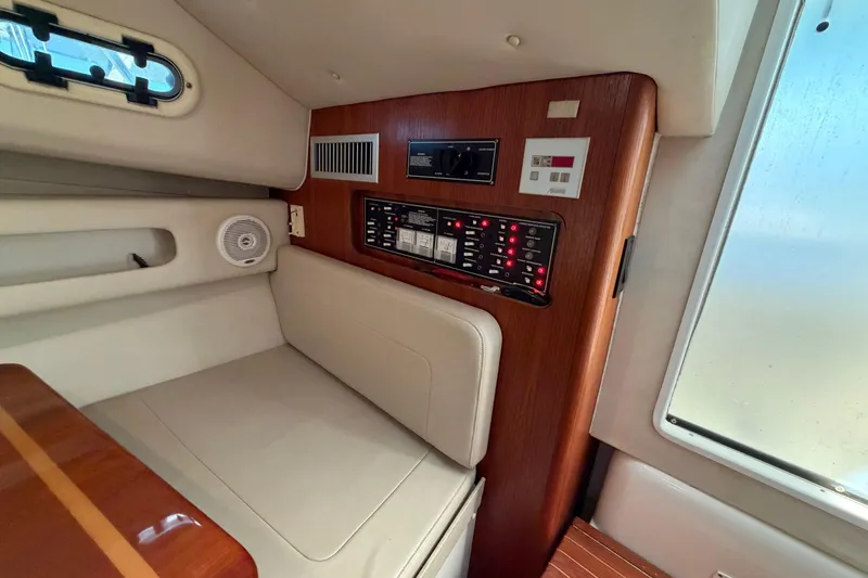 Slide: The Image of Interior of 2001 Pursuit 3000 Express boat with control panel and seating area. - 25