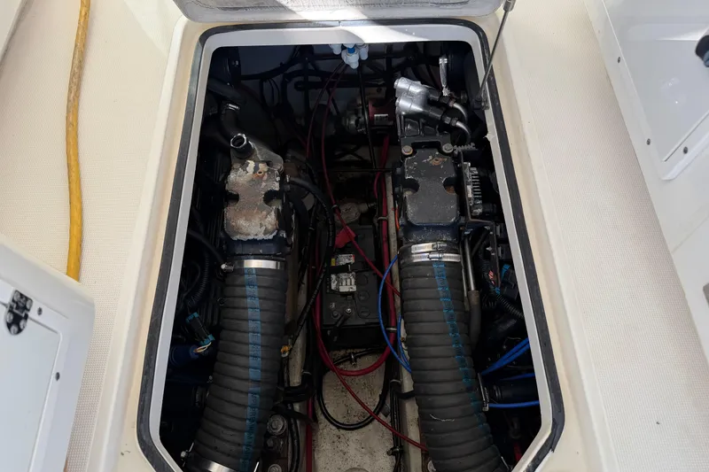 Slide: The Image of Engine compartment of a 2001 Pursuit 3000 Express boat, showing mechanical components and wiring. - 28