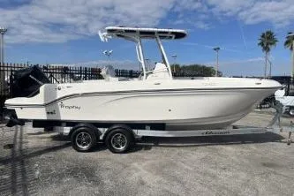 The Image of 2023 Trophy T24 CC boat on trailer, parked outdoors under blue sky. - 1